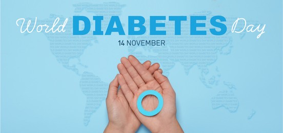 Image of World Diabetes Day, banner design. Woman holding blue paper circle, top view. Illustration of world map on color background