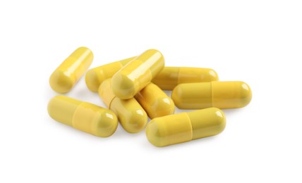Many yellow pills isolated on white. Medicinal treatment