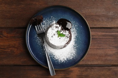 Photo of Delicious fresh fondant with hot chocolate and mint on wooden table, top view