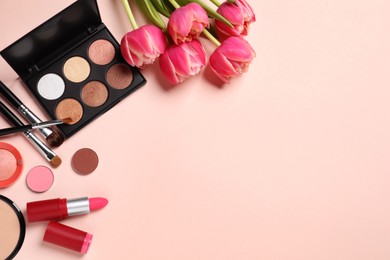 Flat lay composition with different makeup products and beautiful tulips on beige background, space for text