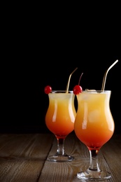 Photo of Just made appetizing cocktails Sex on the Beach, black background. Space for text