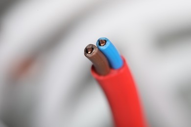 Colorful electrical wire on blurred background, closeup. Space for text