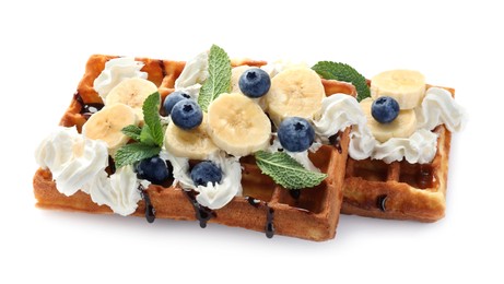 Photo of Delicious Belgian waffles with blueberry, banana, whipped cream and chocolate sauce isolated on white