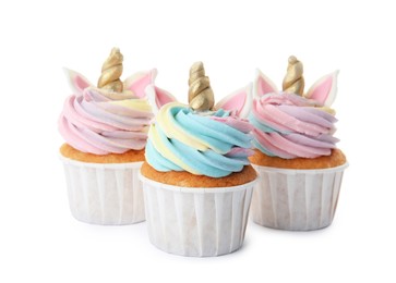 Photo of Three cute sweet unicorn cupcakes on white background