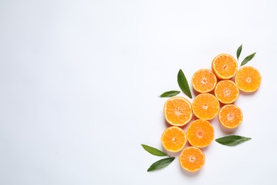 Composition with halves of fresh ripe tangerines and space for text on white background, flat lay. Citrus fruit