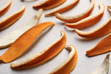 Photo of Many dry orange peels on white table, closeup