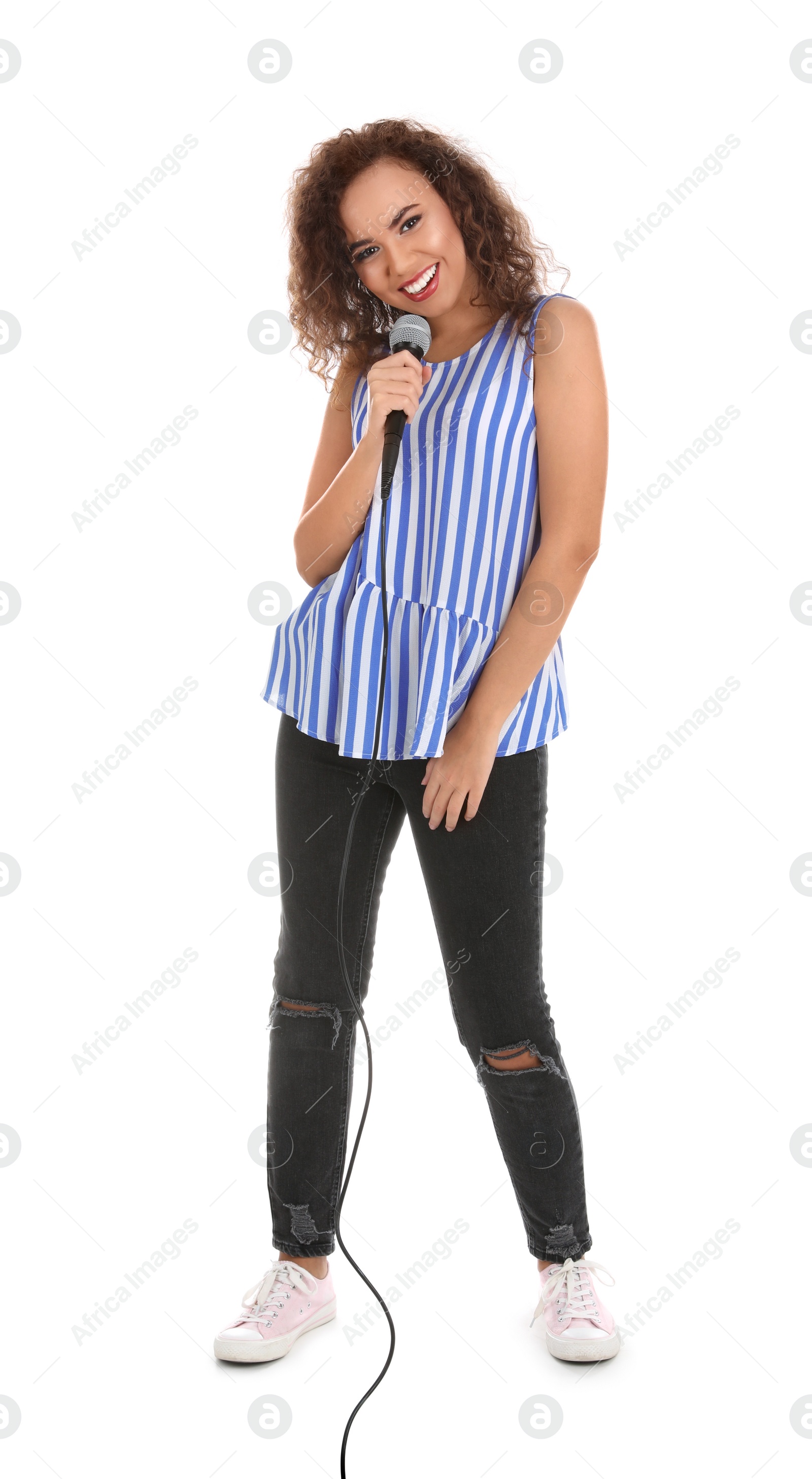 Photo of Curly African-American woman in casual clothes posing with microphone on white background