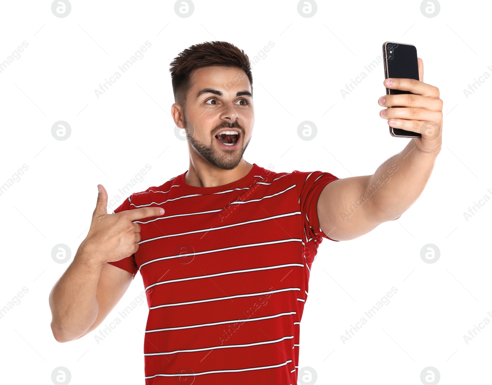 Photo of Excited young man taking selfie on white background