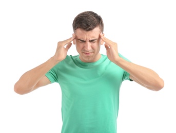 Young man suffering from headache on white background