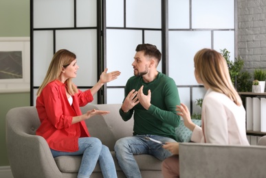 Photo of Young couple with problem at family psychologist office