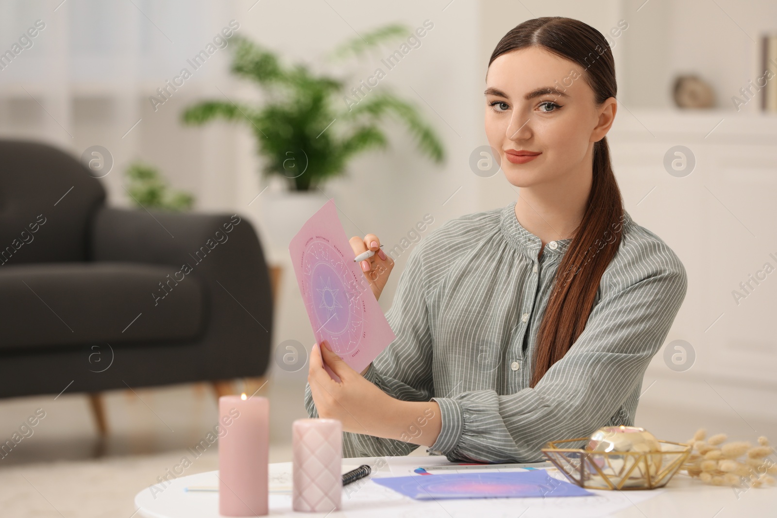 Photo of Astrologer making fate forecast at table indoors, space for text. Fortune telling