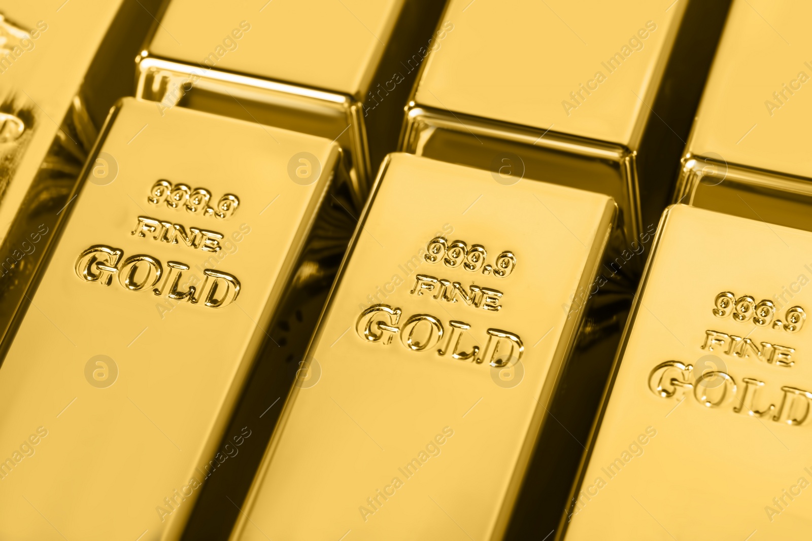 Photo of Many shiny gold bars as background, closeup