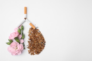 No smoking concept. Lungs made of dry tobacco, cigarettes and pink flowers on white background, flat lay with space for text