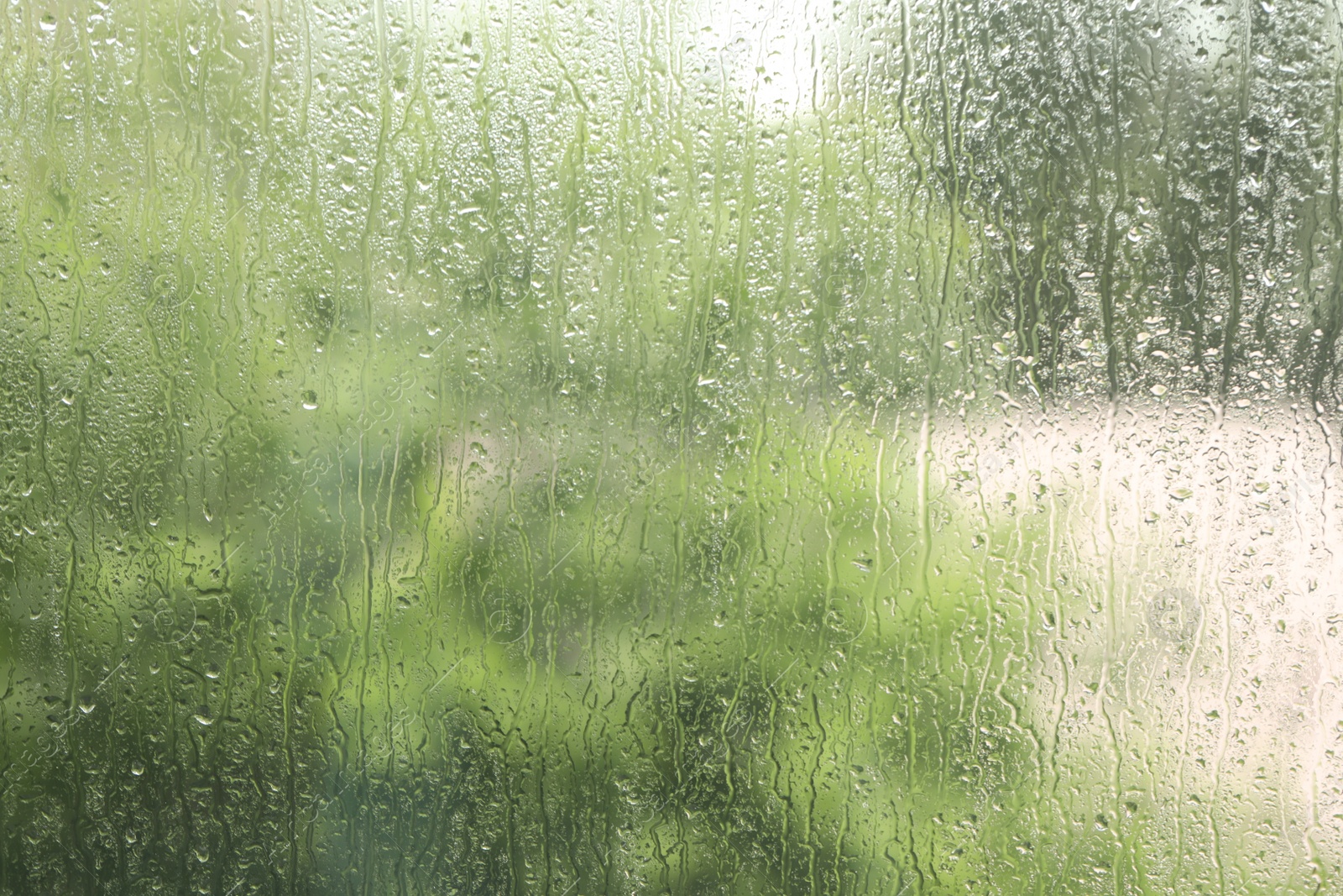 Photo of Window glass with raindrops as background, closeup