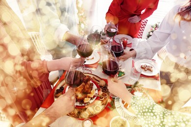 Image of Family with their friends clinking glasses at festive dinner indoors, closeup. Christmas Eve celebration