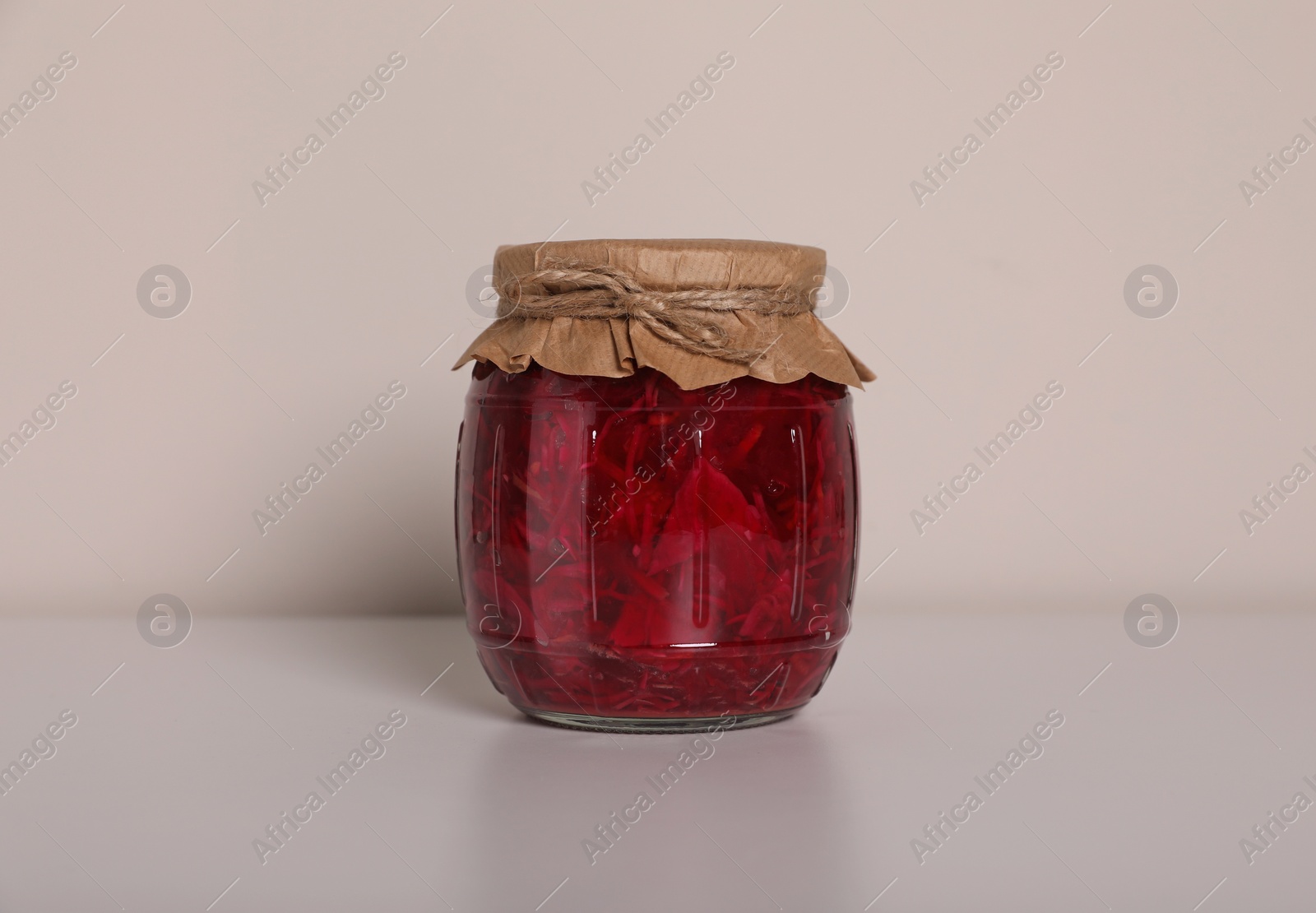 Photo of Jar of tasty pickled beets on white background