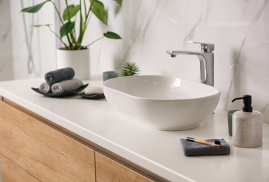 Photo of Stylish vessel sink on light countertop in modern bathroom