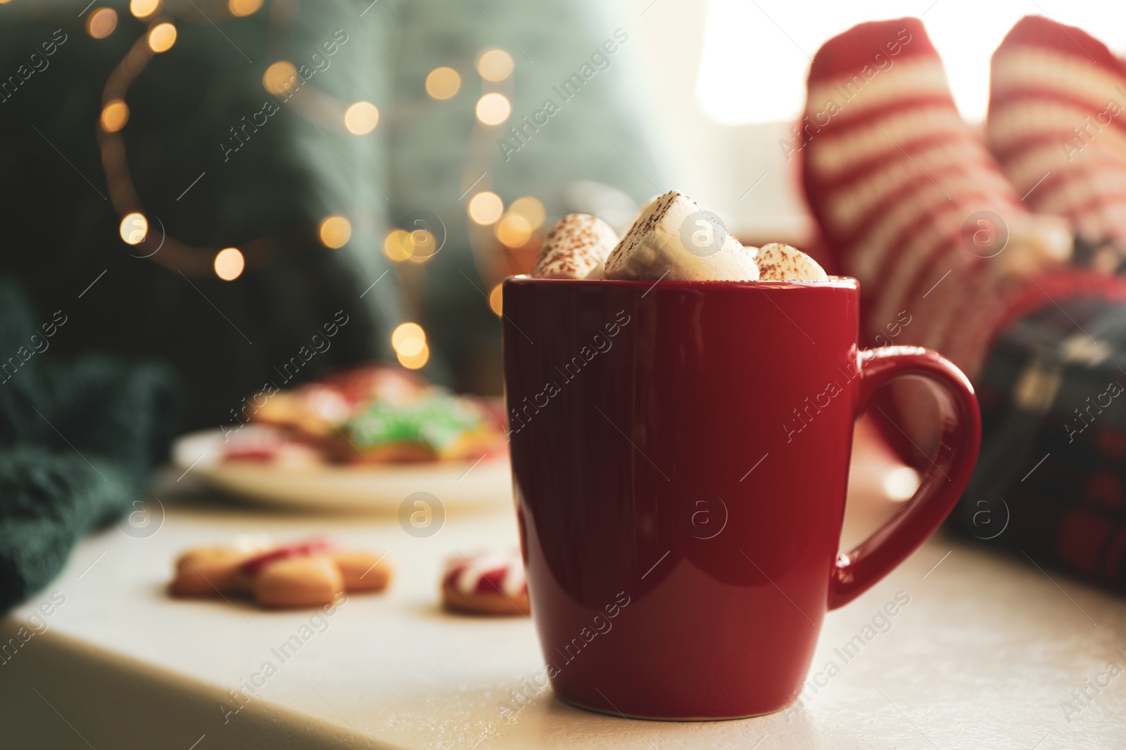 Photo of Cup of delicious hot cocoa with marshmallows on white table. Winter drink