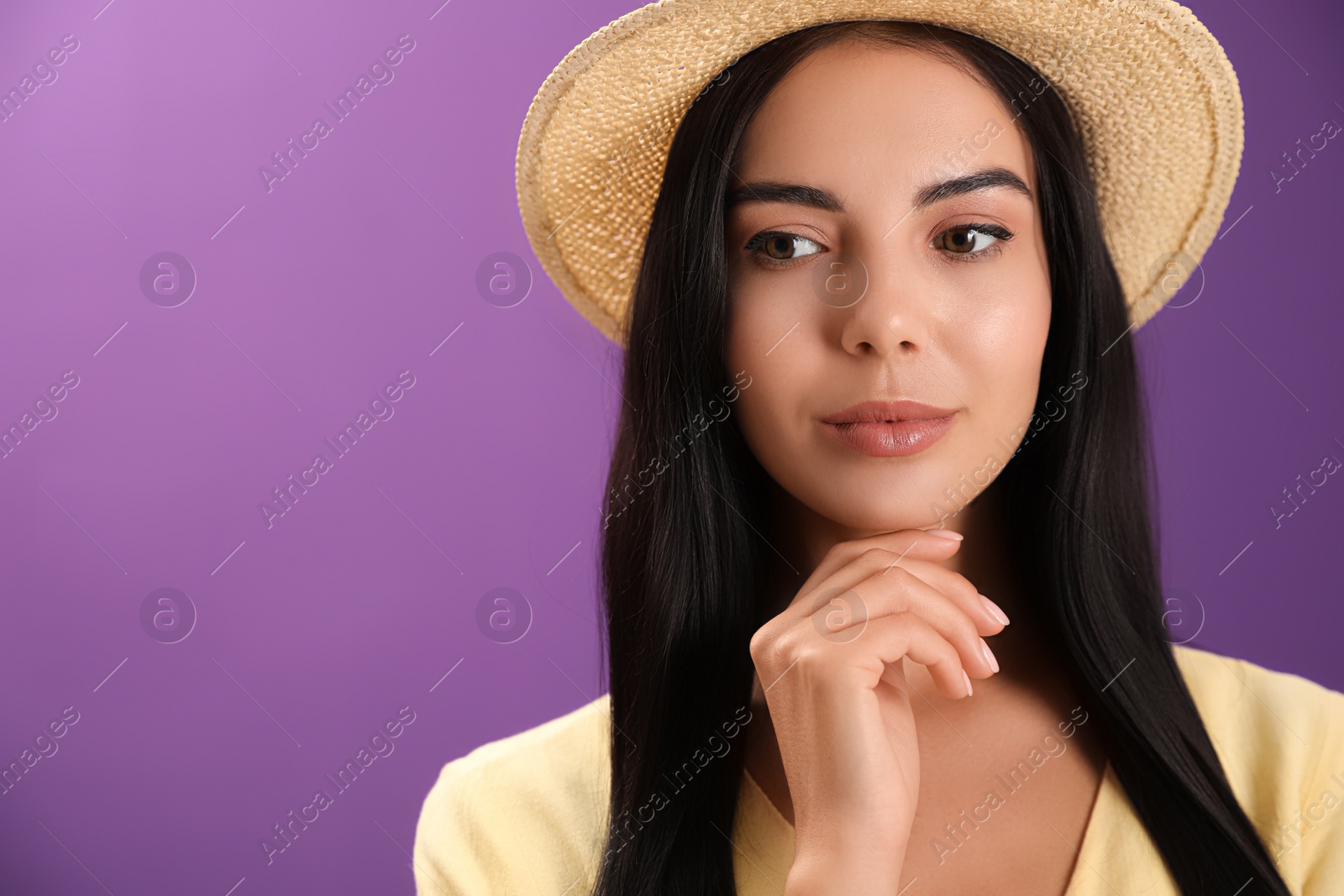 Photo of Portrait of beautiful young woman on purple background