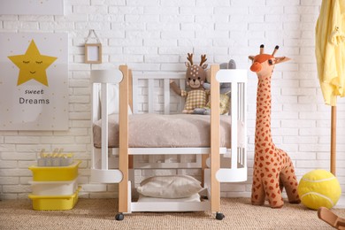 Photo of Baby room interior with toys and stylish furniture