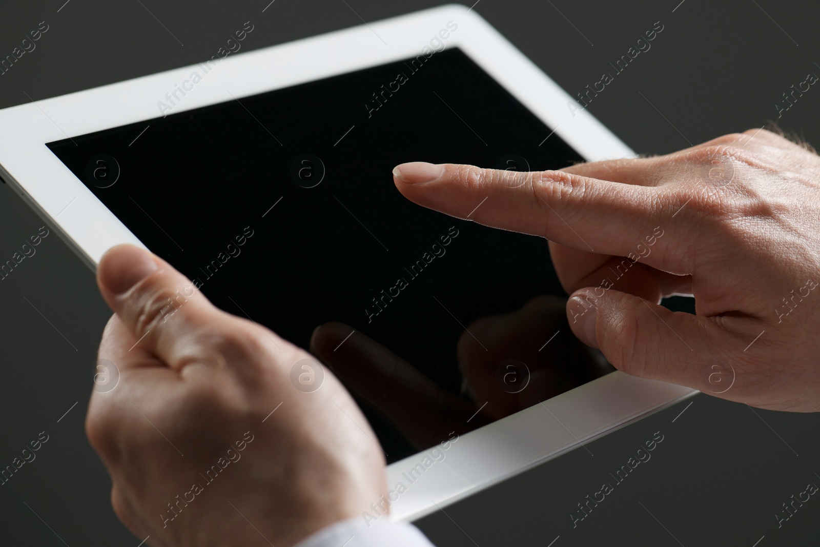 Photo of Closeup view of man using new tablet indoors