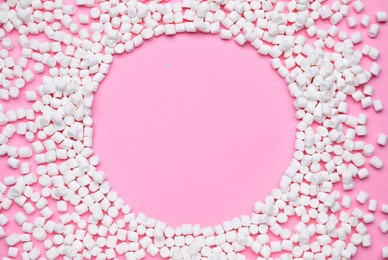 Photo of Frame made of sweet marshmallows on pink background, flat lay