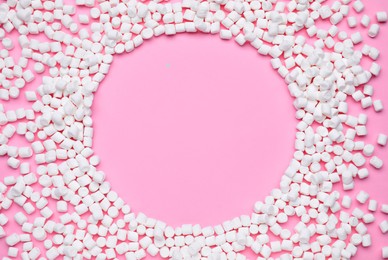 Frame made of sweet marshmallows on pink background, flat lay