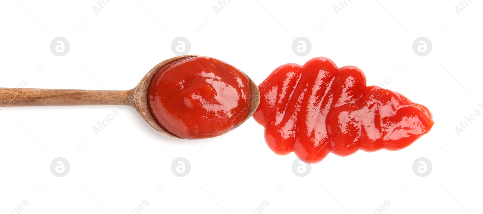 Photo of Tasty ketchup with wooden spoon isolated on white, top view. Tomato sauce