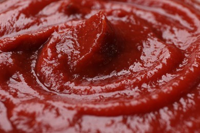 Photo of Organic ketchup as background, closeup. Tomato sauce