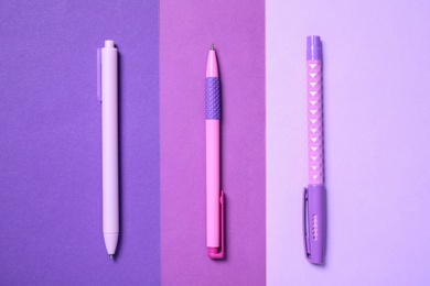 Photo of Bright pens on color background, flat lay