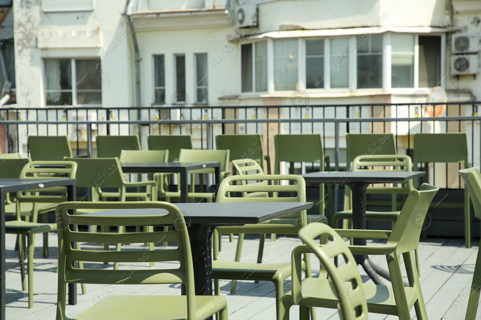 Photo of Observation area cafe. Tables and chairs on terrace against beautiful cityscape