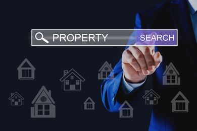 Image of Property search concept. Man using virtual screen with search bar and house illustrations, closeup
