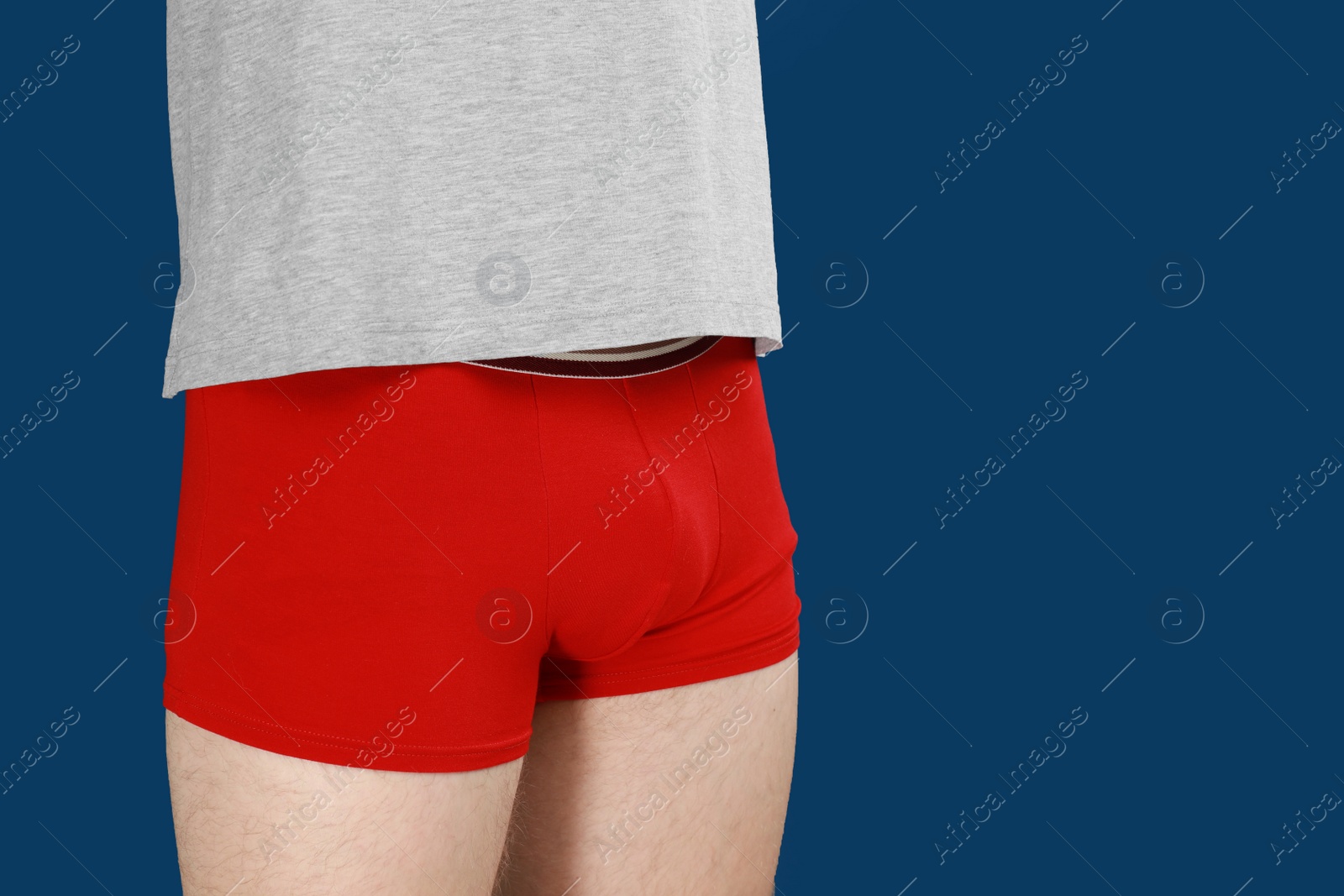 Photo of Man in underwear on blue background, closeup. Urology problems