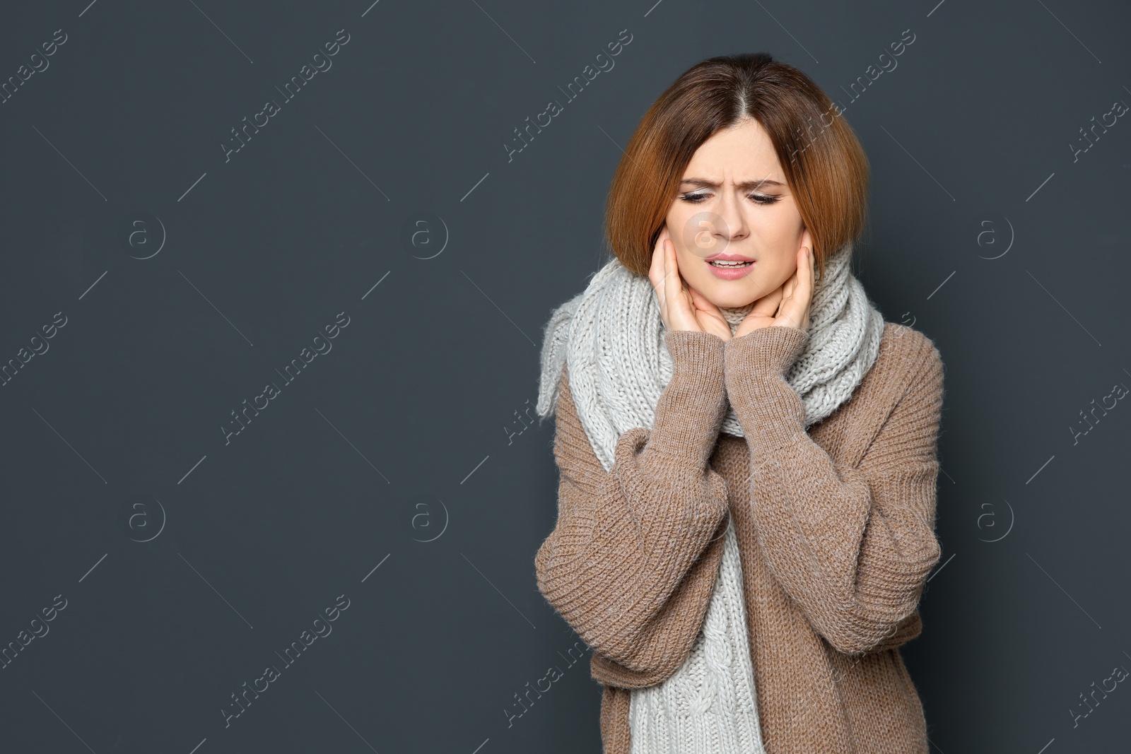 Photo of Woman suffering from cough on dark background. Space for text