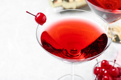 Photo of Glass of fresh cocktail with cherry, closeup
