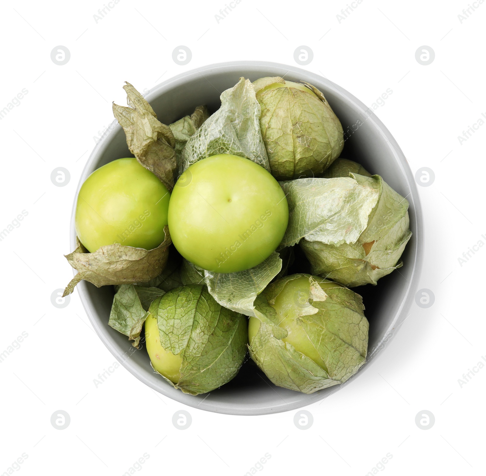 Photo of Bowl of fresh green tomatillos with husk isolated on white, top view