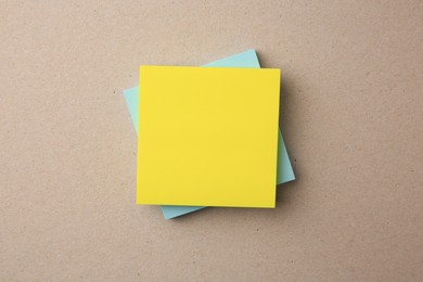 Blank paper notes on beige background, top view