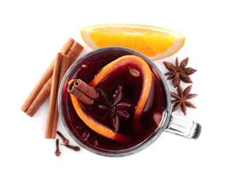 Aromatic mulled wine and ingredients on white background, top view