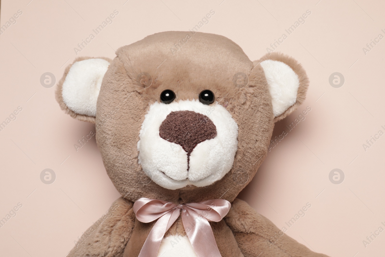 Photo of Cute teddy bear on beige background, top view