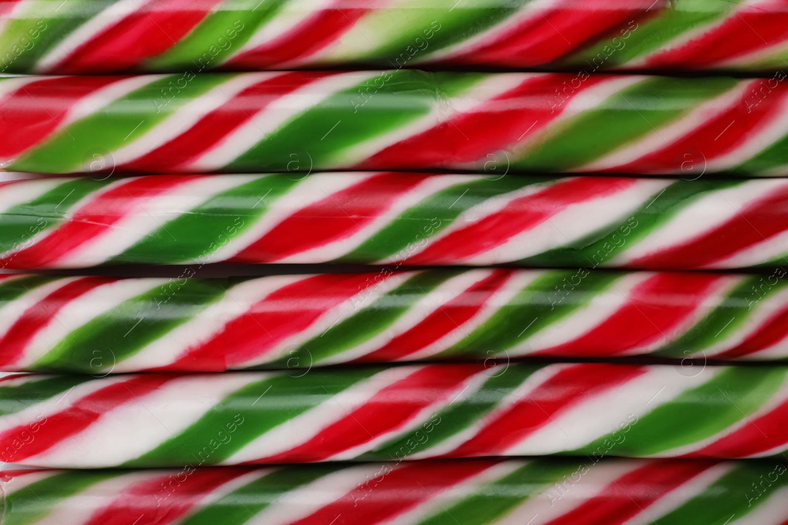 Photo of Top view of many sweet Christmas candy canes as background, closeup