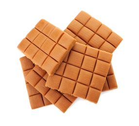 Delicious caramel candies on white background