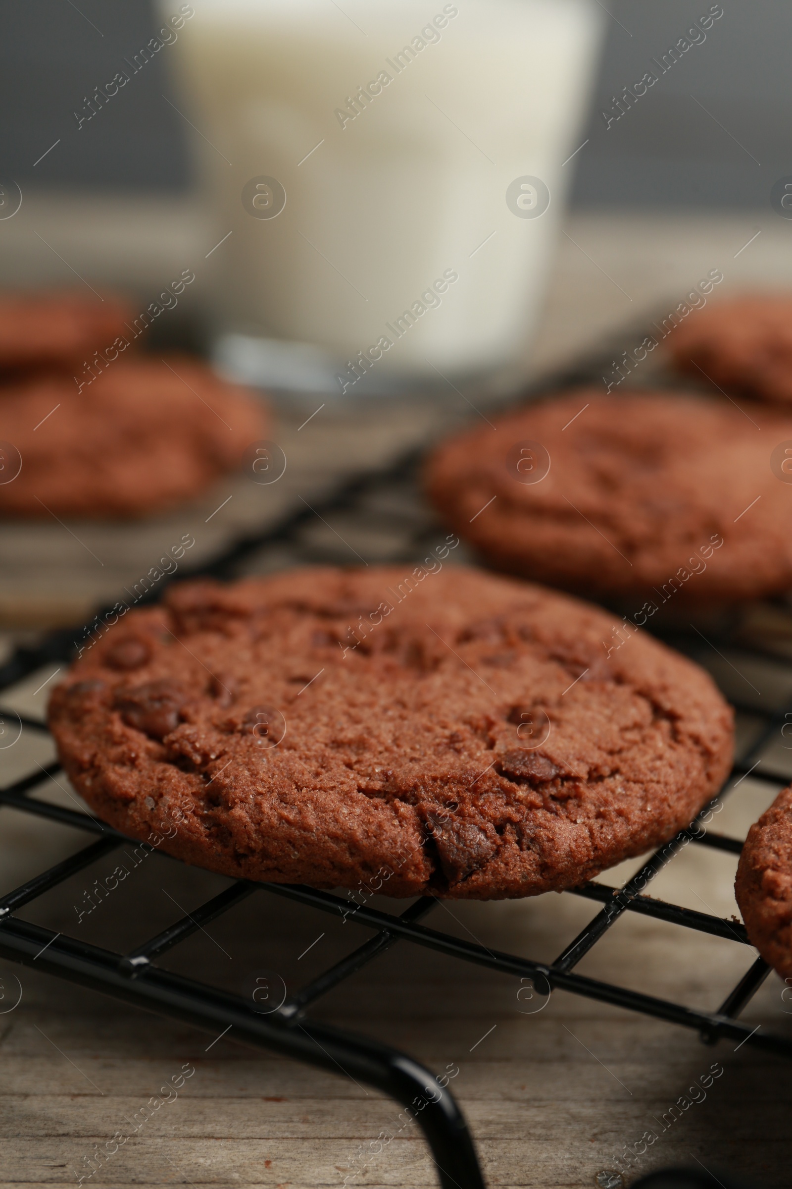 Photo of Delicious chocolate chip cookies on wooden table, closeup