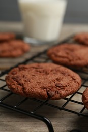 Photo of Delicious chocolate chip cookies on wooden table, closeup