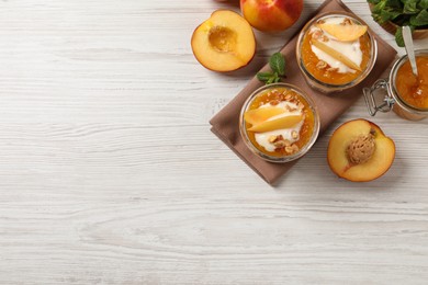 Photo of Flat lay composition with tasty peach yogurt on white wooden table. Space for text