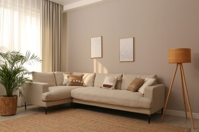 Photo of Stylish living room interior with modern comfortable sofa and pictures