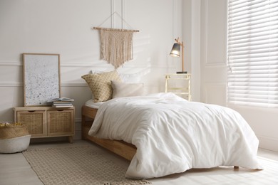 Photo of Comfortable bed with clean white linens indoors