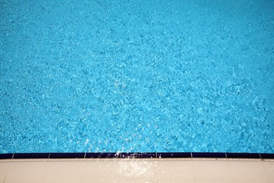 Photo of Outdoor swimming pool with clear water on sunny day, above view