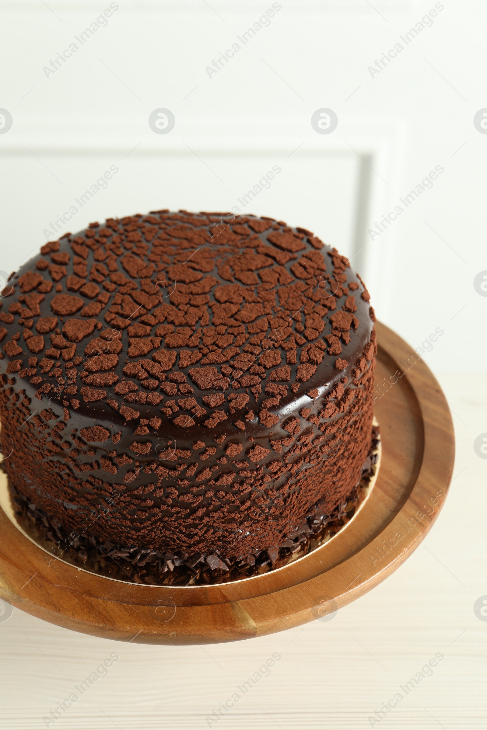 Photo of Delicious chocolate truffle cake on light wooden table