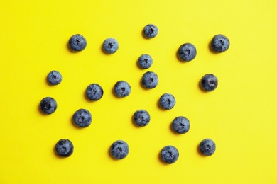 Photo of Flat lay composition with tasty blueberry on color background