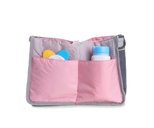 Photo of Maternity bag with baby accessories on white background